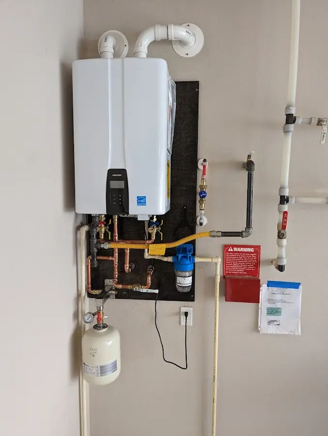 Professional plumber installing copper piping in a Telford home